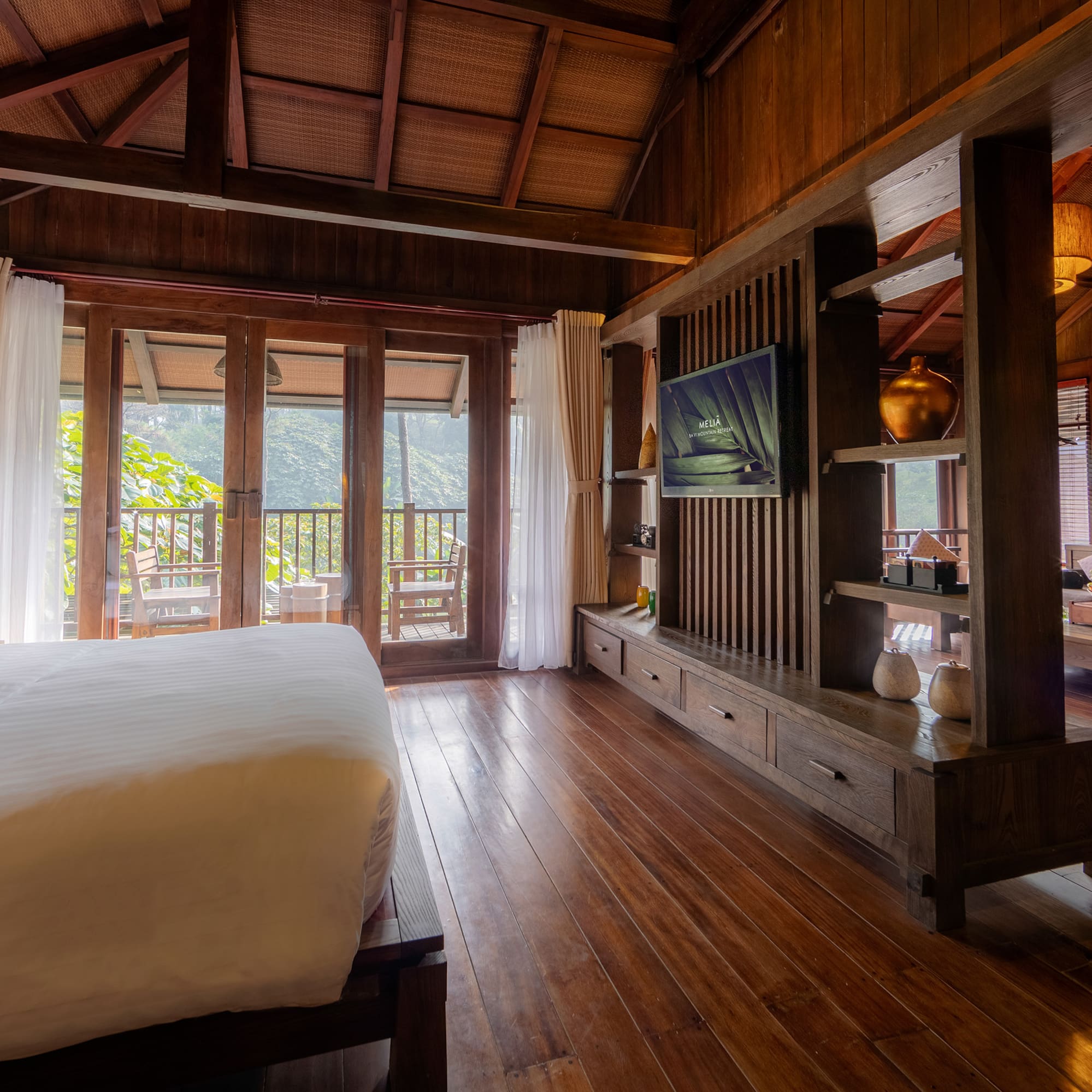 a room with a bed and a television