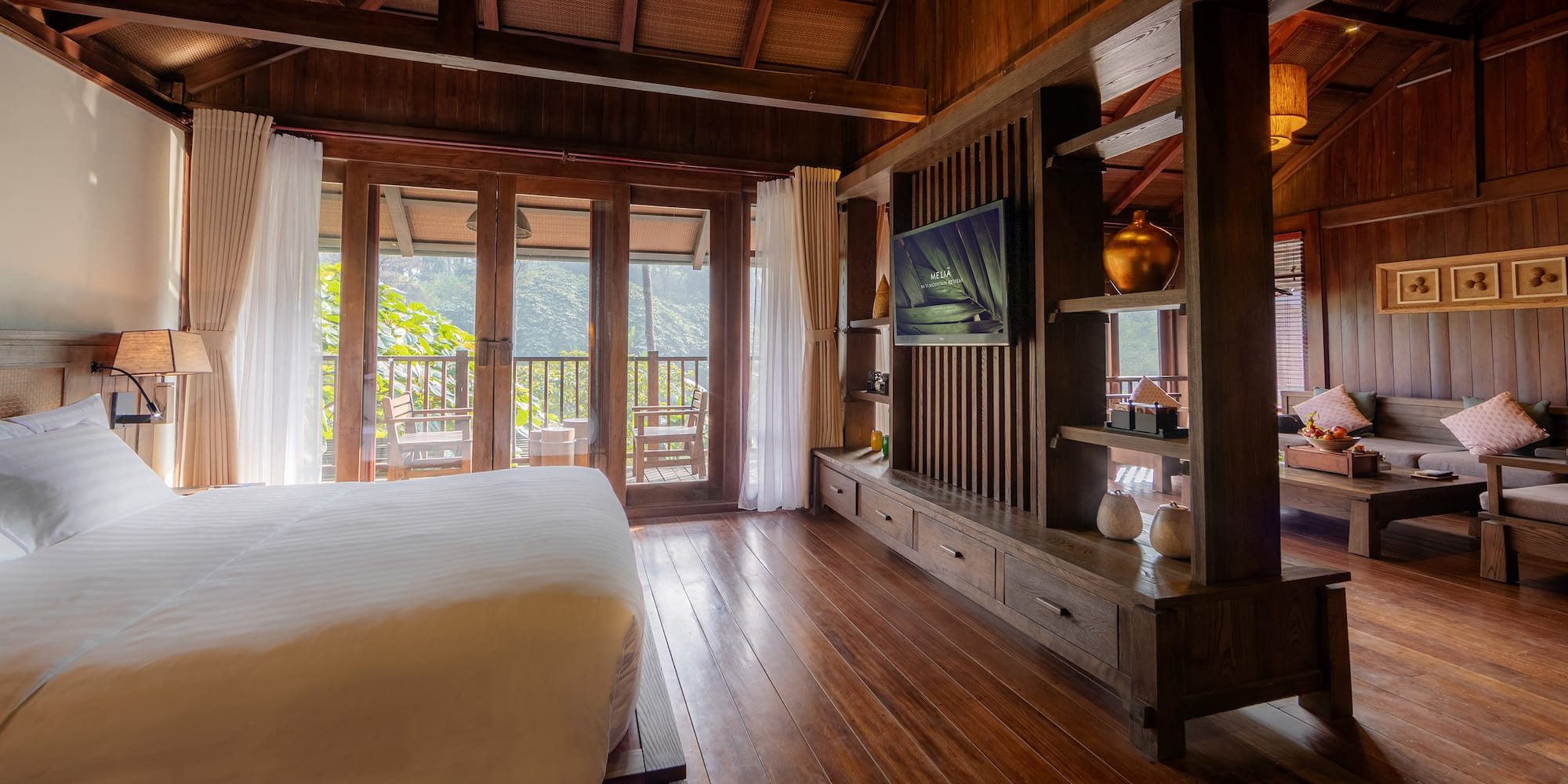 a room with a bed and a television