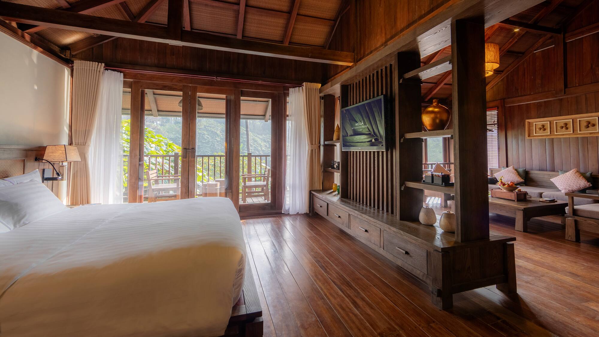 a room with a bed and a television