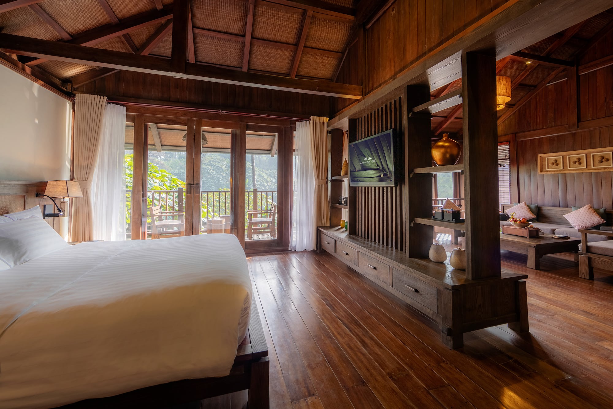 a room with a bed and a television