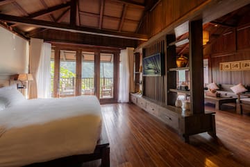 a room with a bed and a television