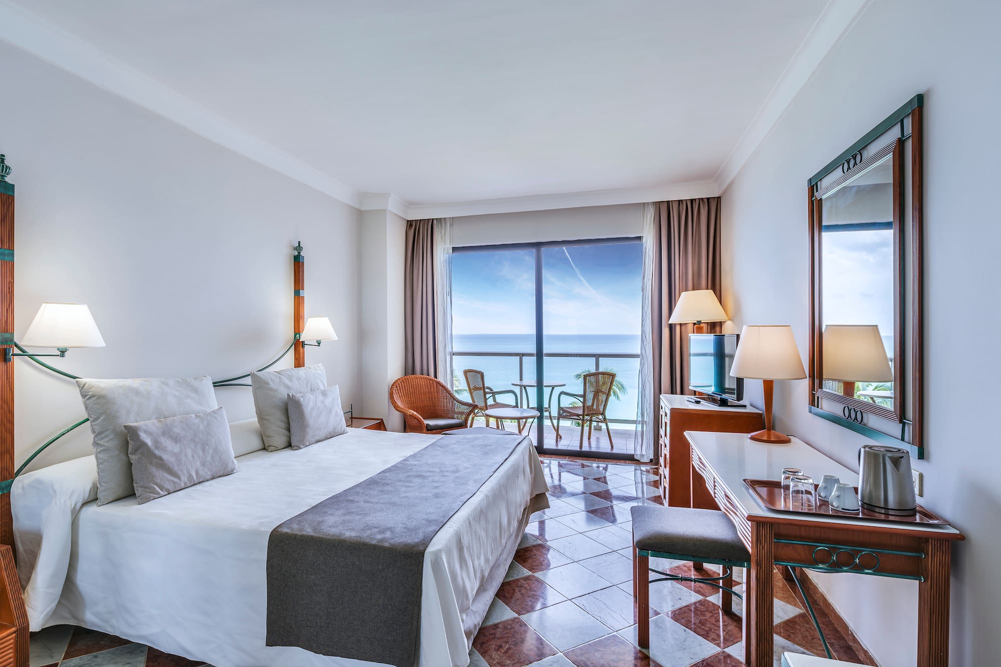 a room with a large window and a bed