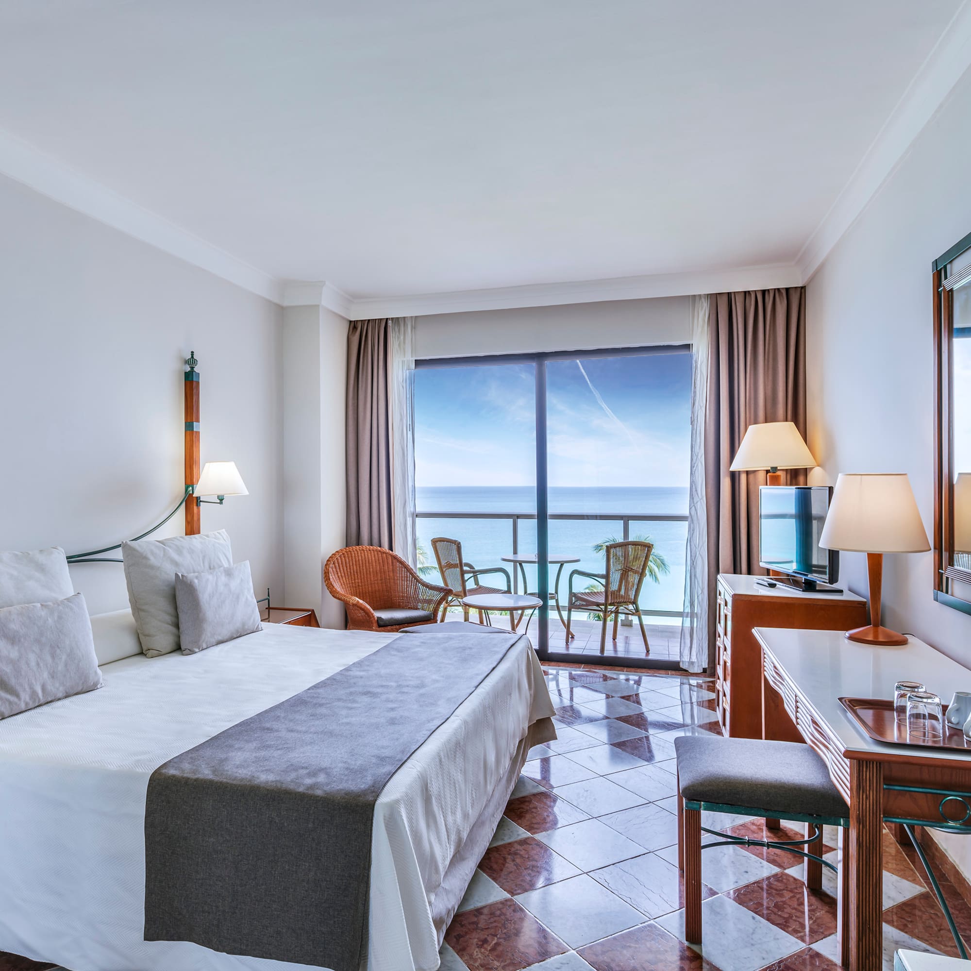 a room with a large window and a bed