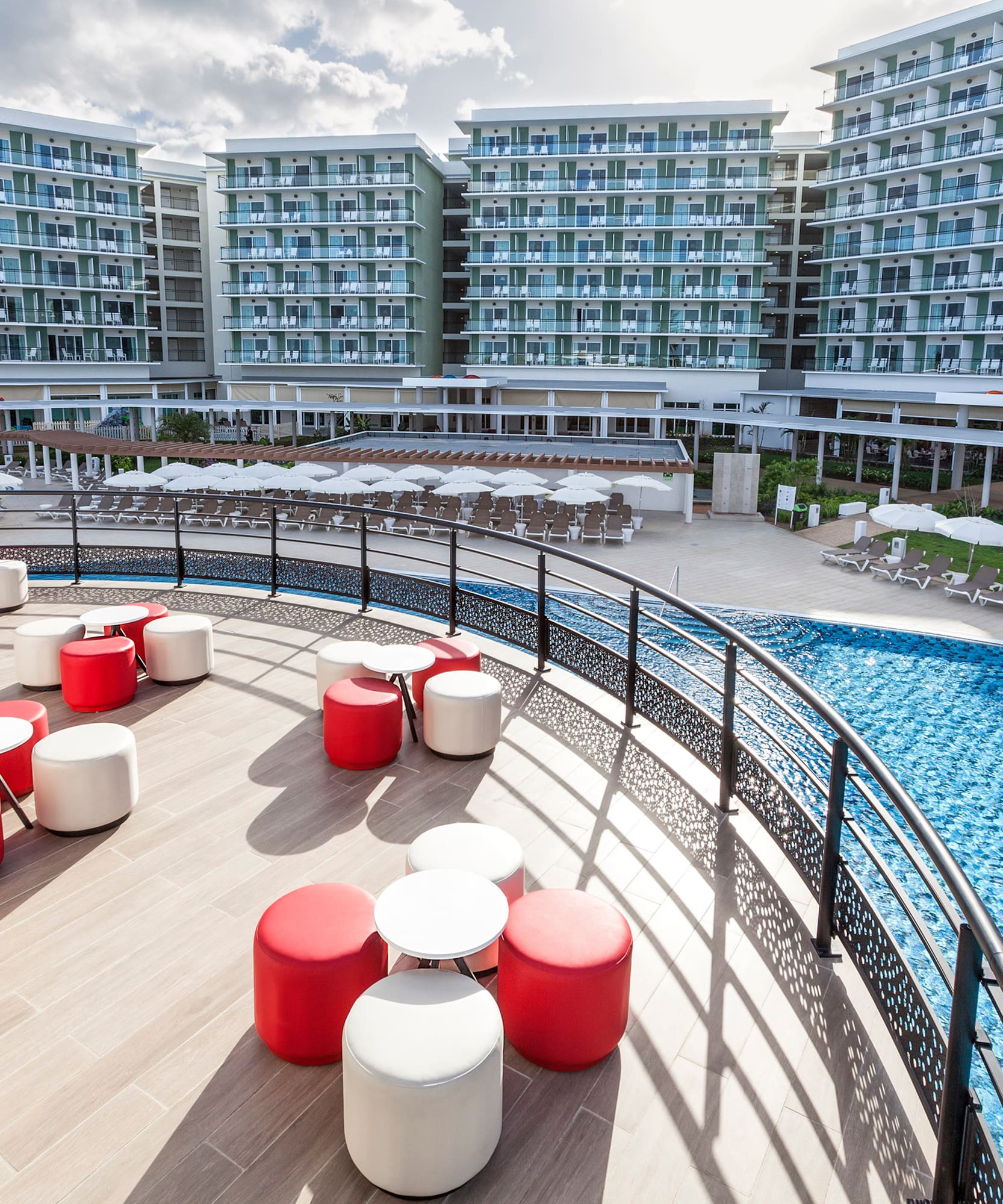 a pool with chairs and tables