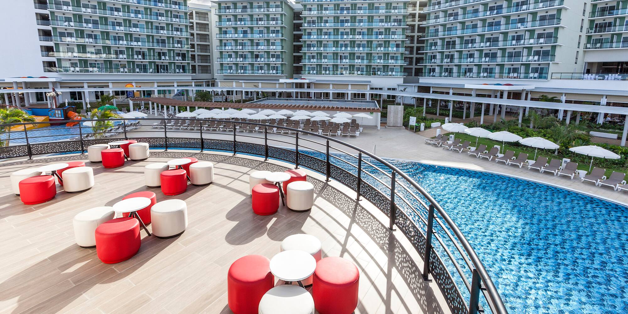 a pool with chairs and tables