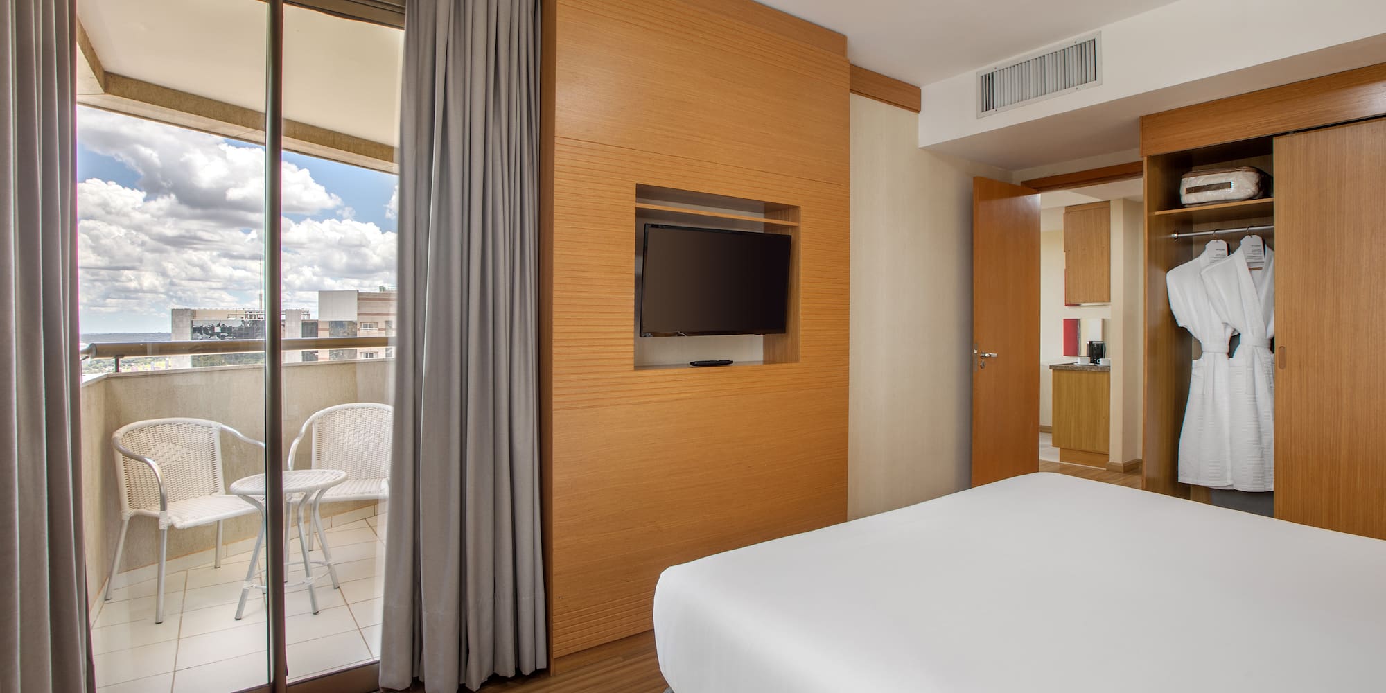 a room with a bed and a television