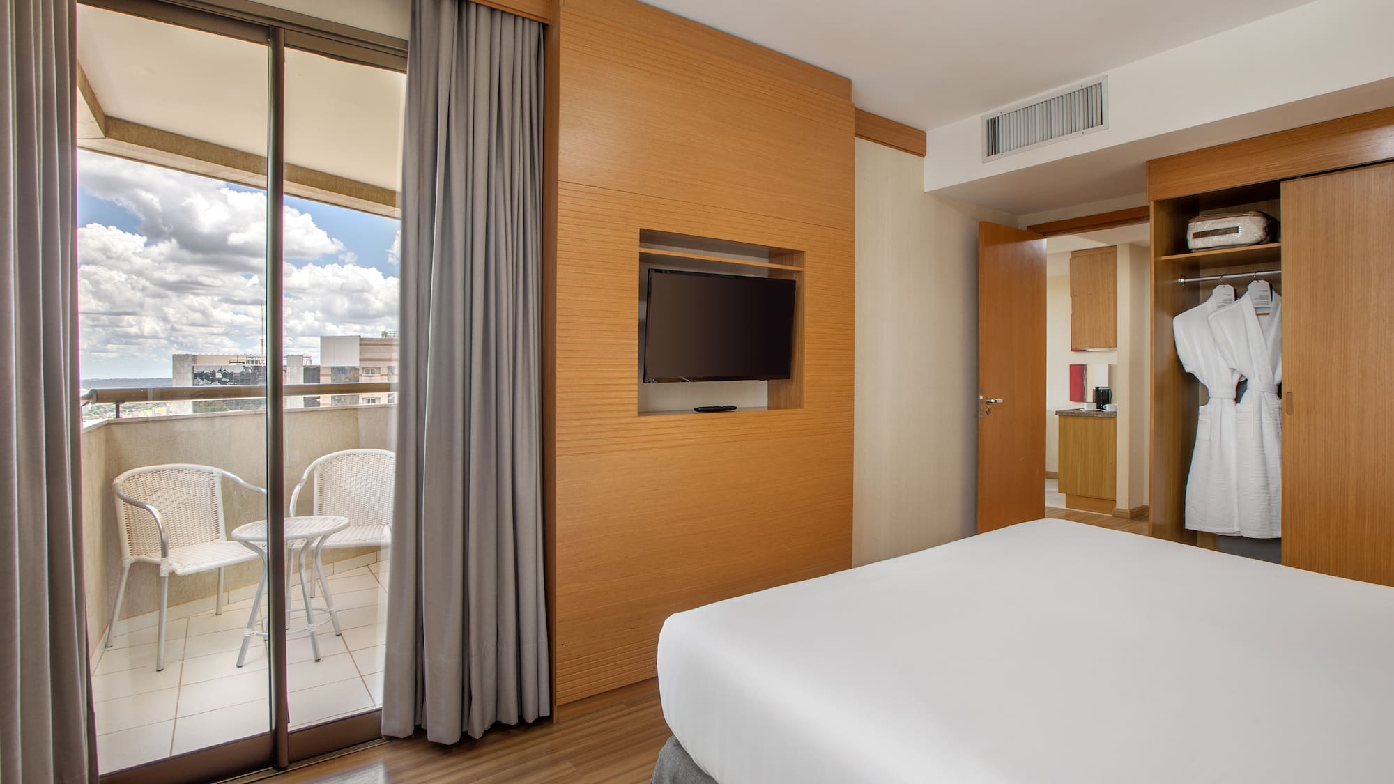 a room with a bed and a television