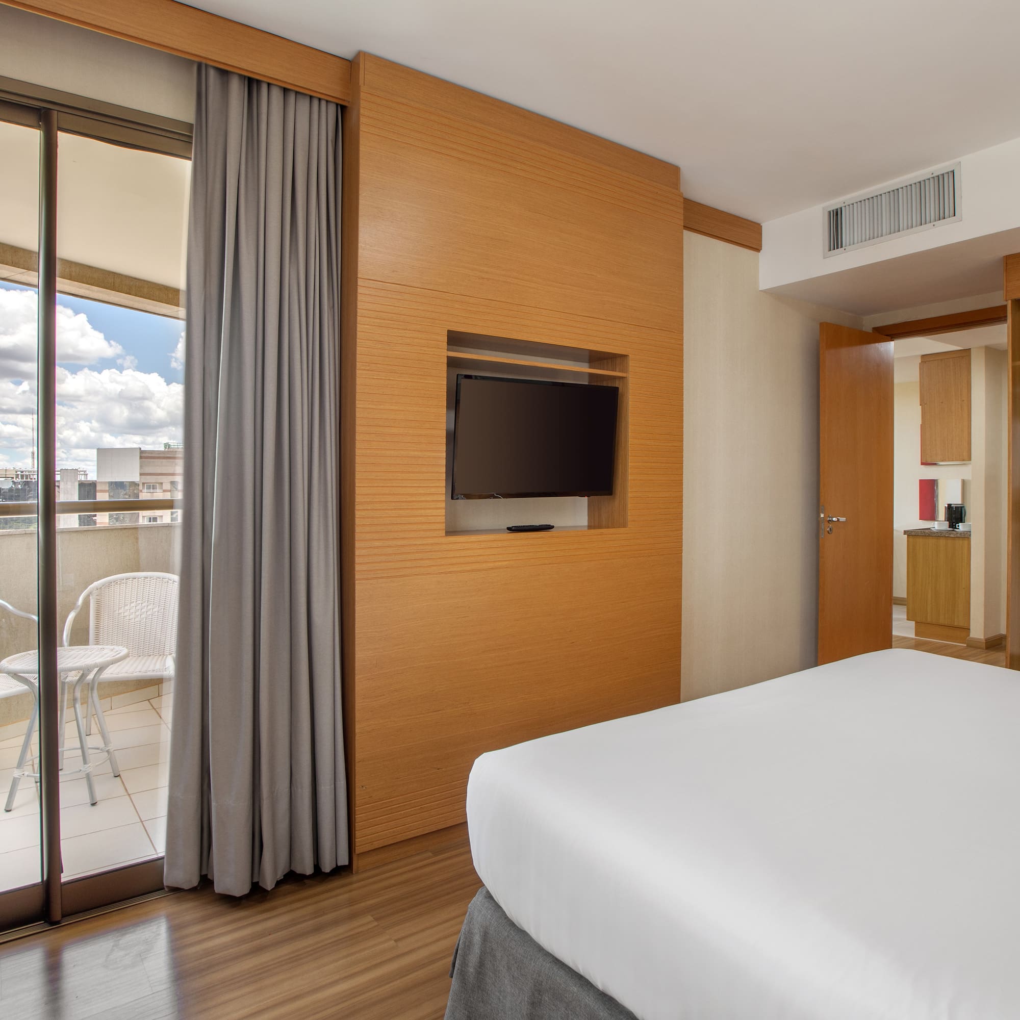 a room with a bed and a television