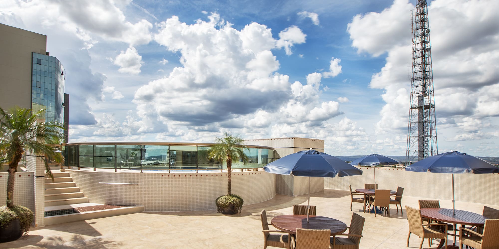 a patio with tables and umbrellas