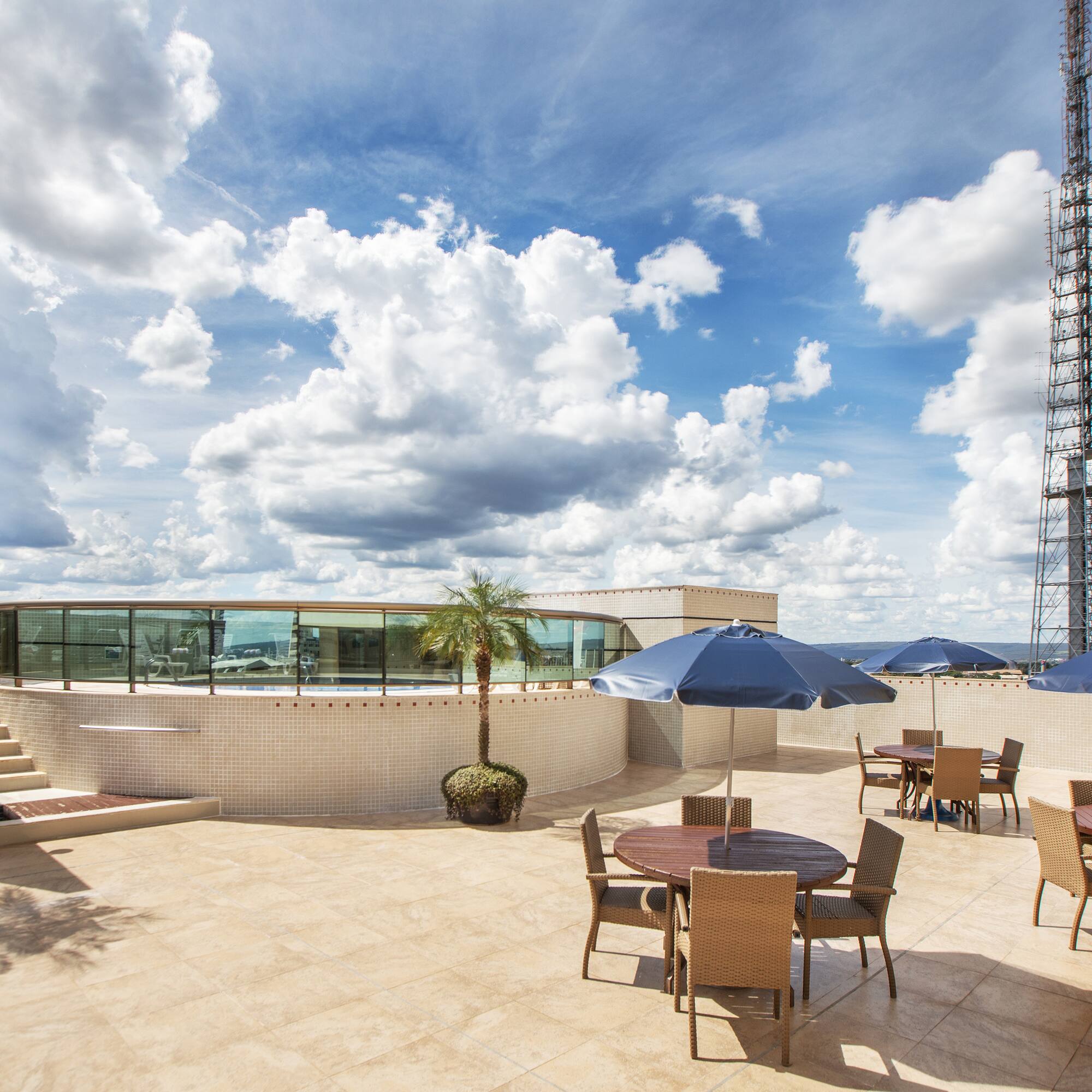 a patio with tables and umbrellas