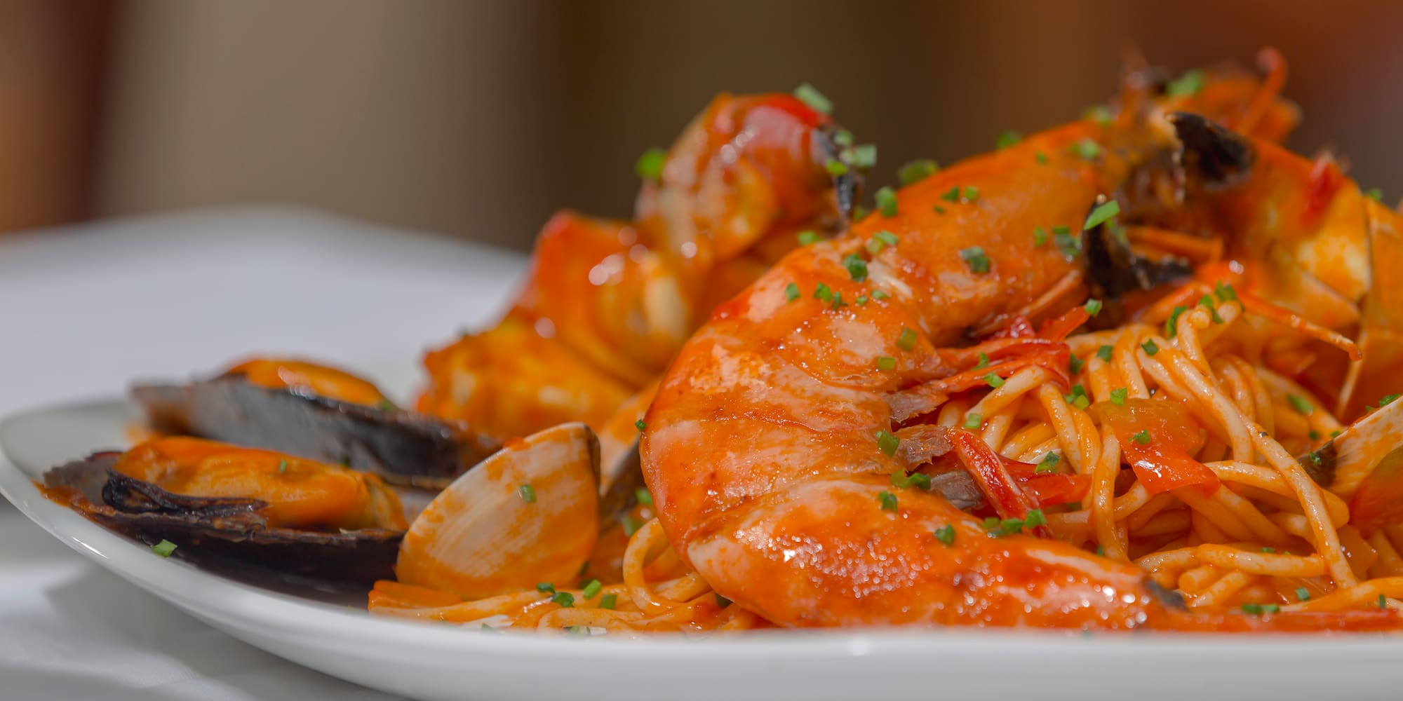a plate of seafood spaghetti and shrimp