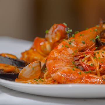 a plate of seafood spaghetti and shrimp