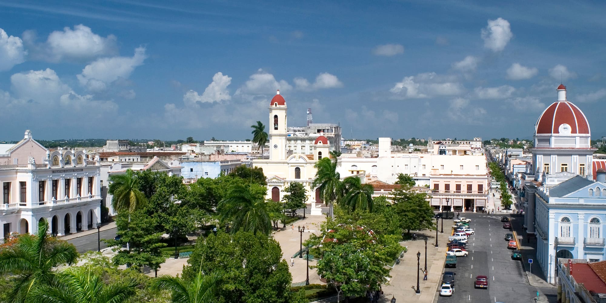 a city with a tall tower and trees