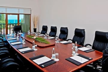 a conference table with chairs and a plant on top