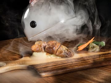 a food on a cutting board with steam coming out of it