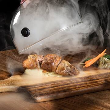 a food on a cutting board with steam coming out of it