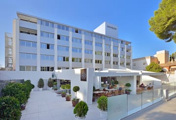 a building with a white wall and a glass fence