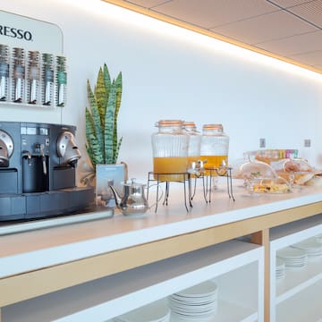 a coffee machine and drinks on a counter