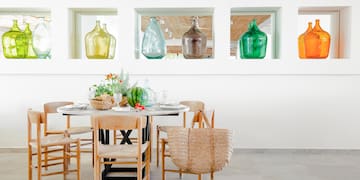 a table with chairs and baskets on it