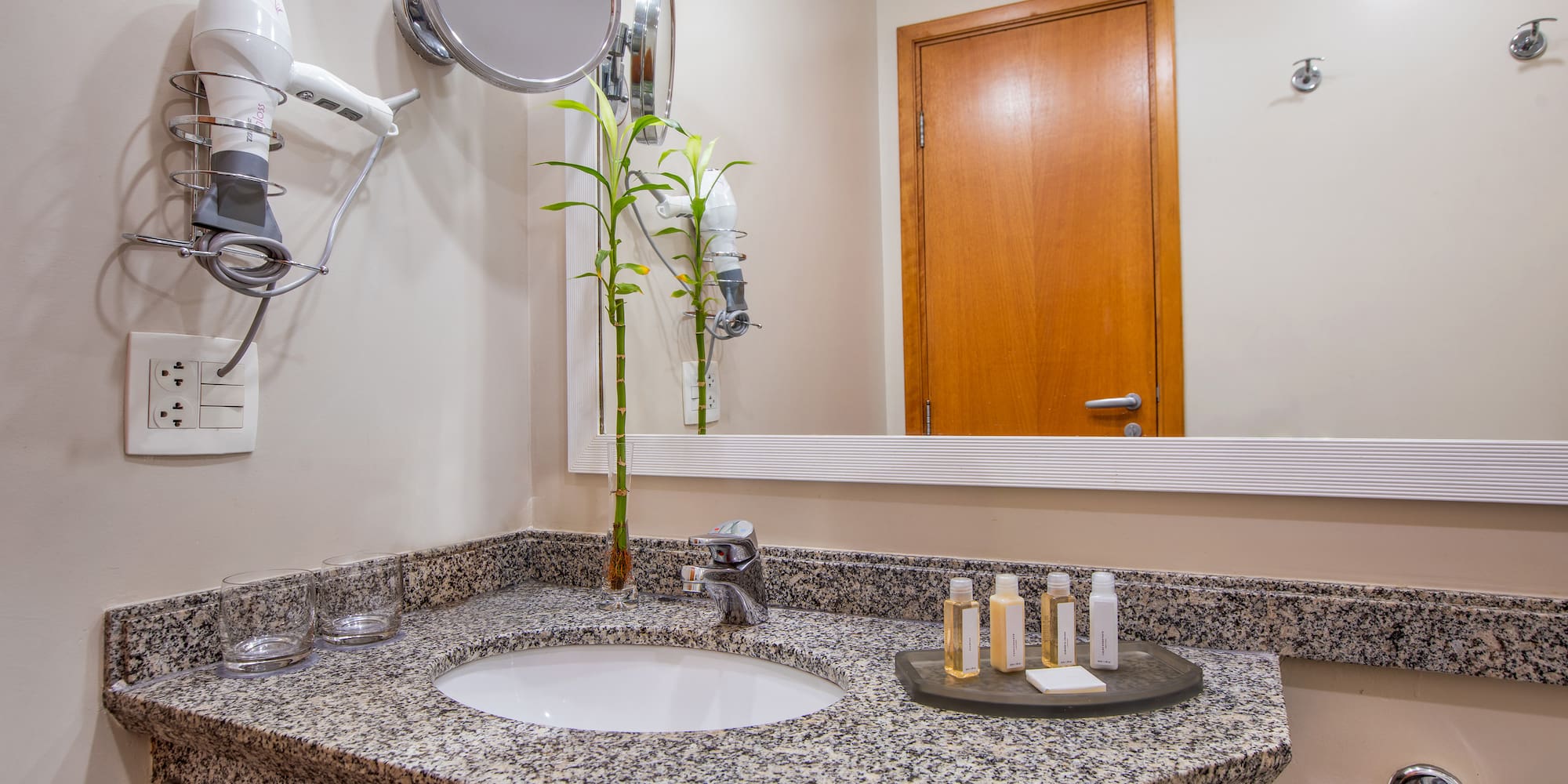 a bathroom with a mirror and a sink
