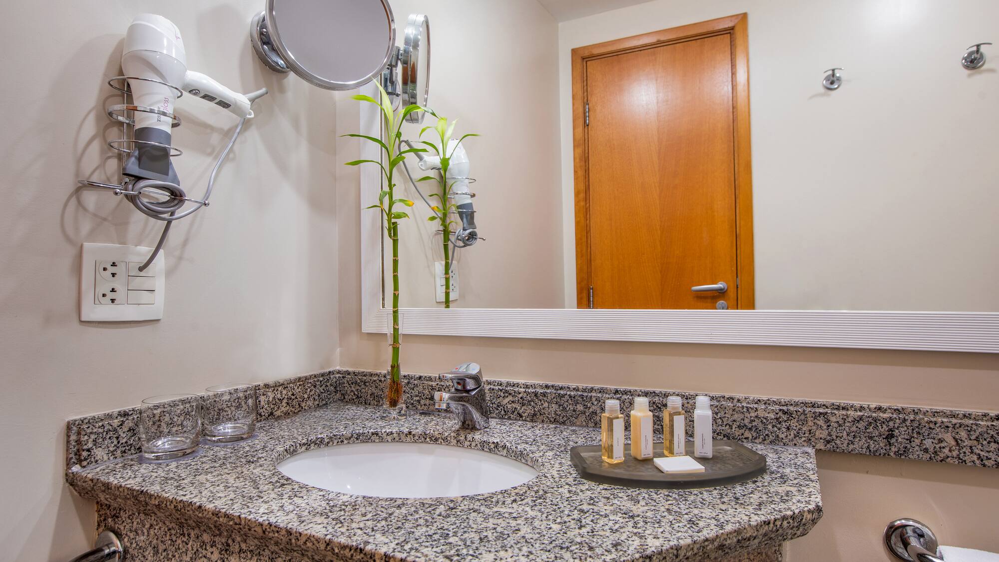 a bathroom with a mirror and a sink