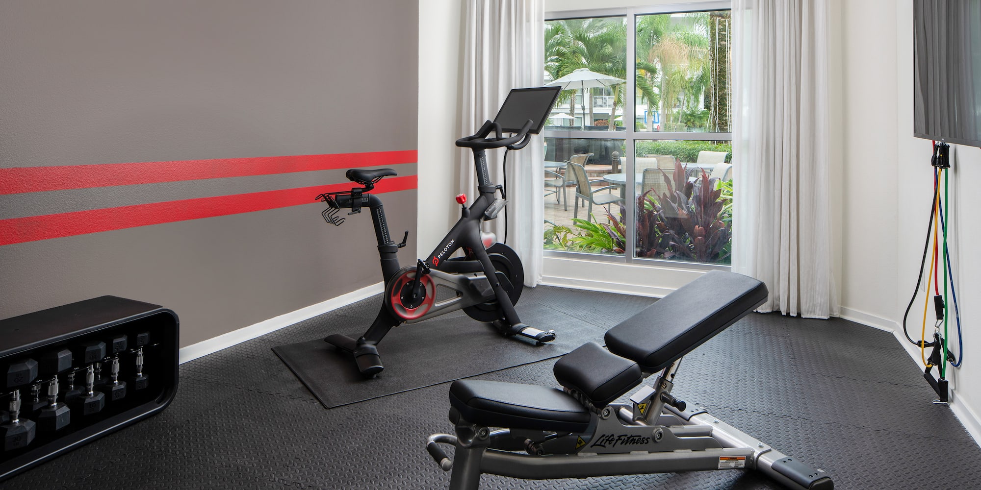 a room with exercise bikes and a window