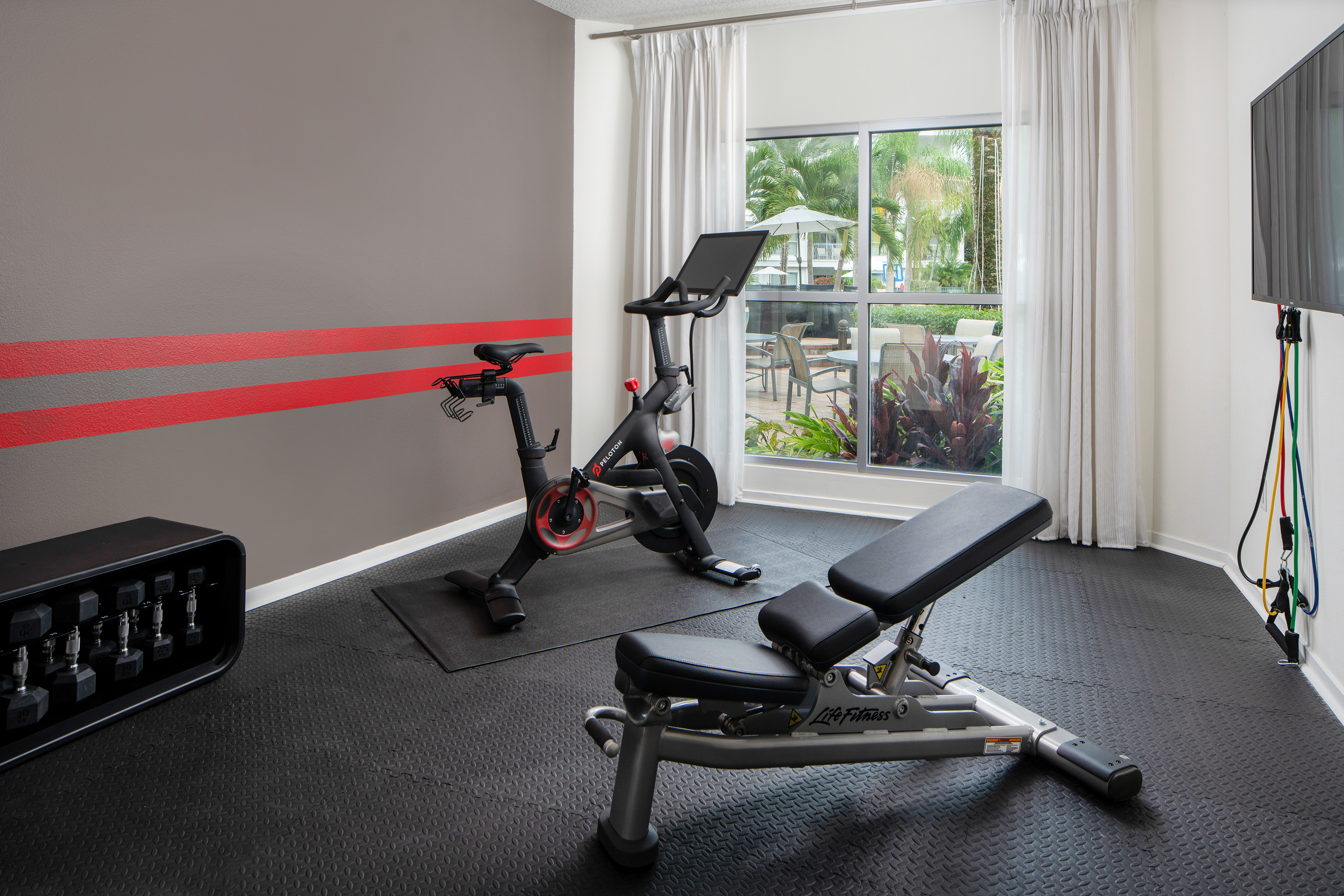 a room with exercise bikes and a window