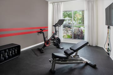 a room with exercise bikes and a window