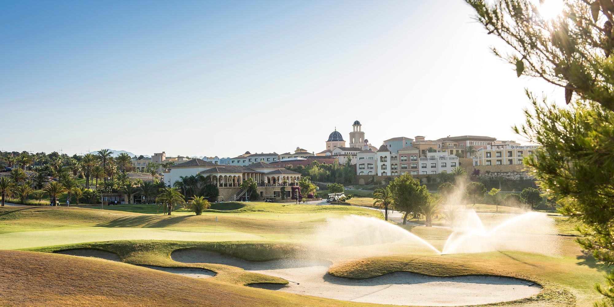 a water sprinklers spraying water on a golf course