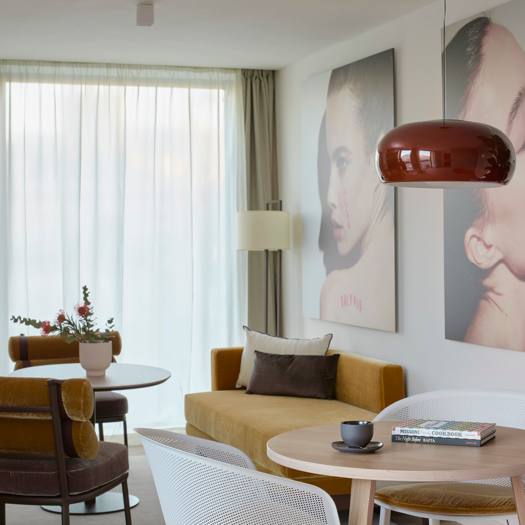 a living room with a couch and pictures on the wall