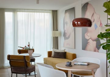 a living room with a couch and pictures on the wall