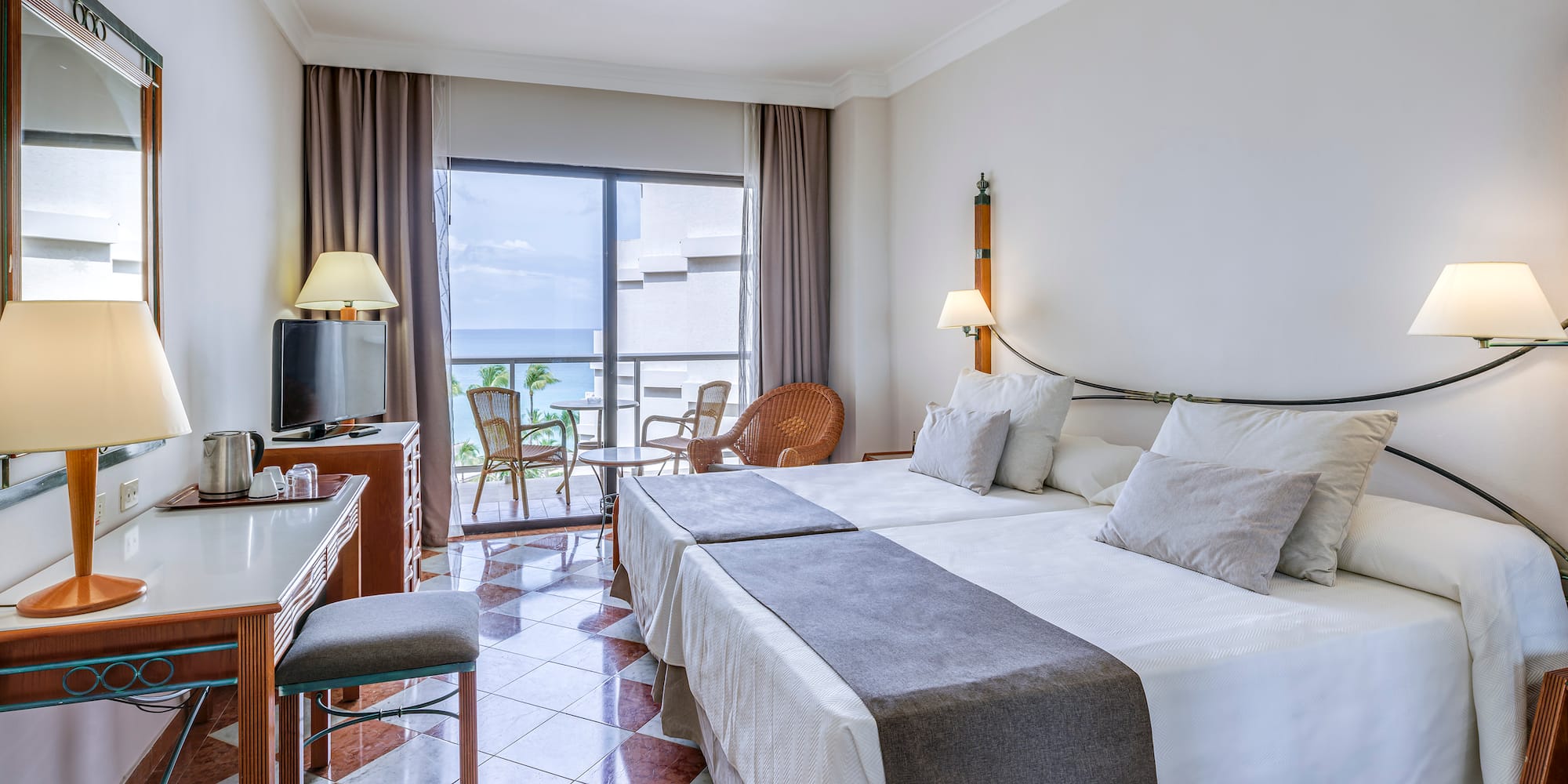 a room with a bed and a table and chairs