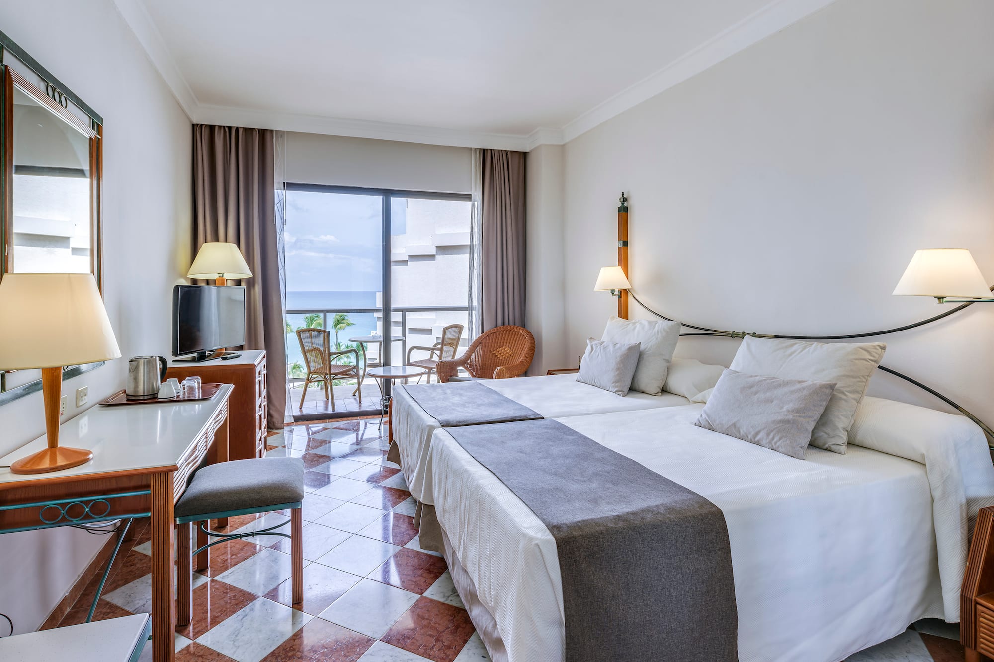 a room with a bed and a table and chairs