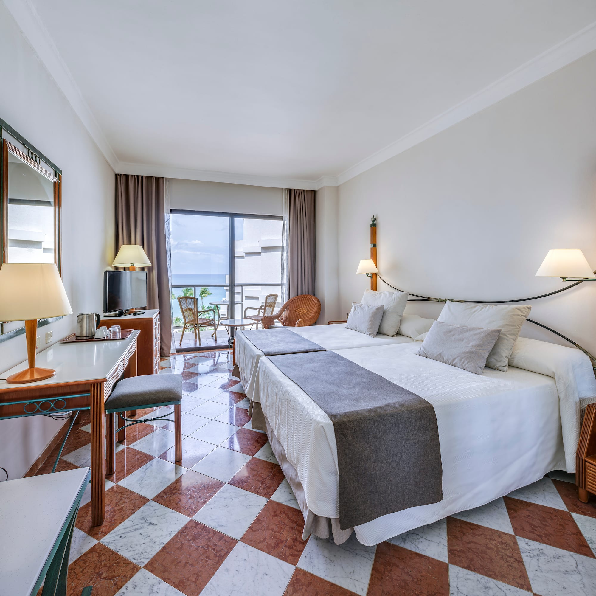 a room with a bed and a table and chairs