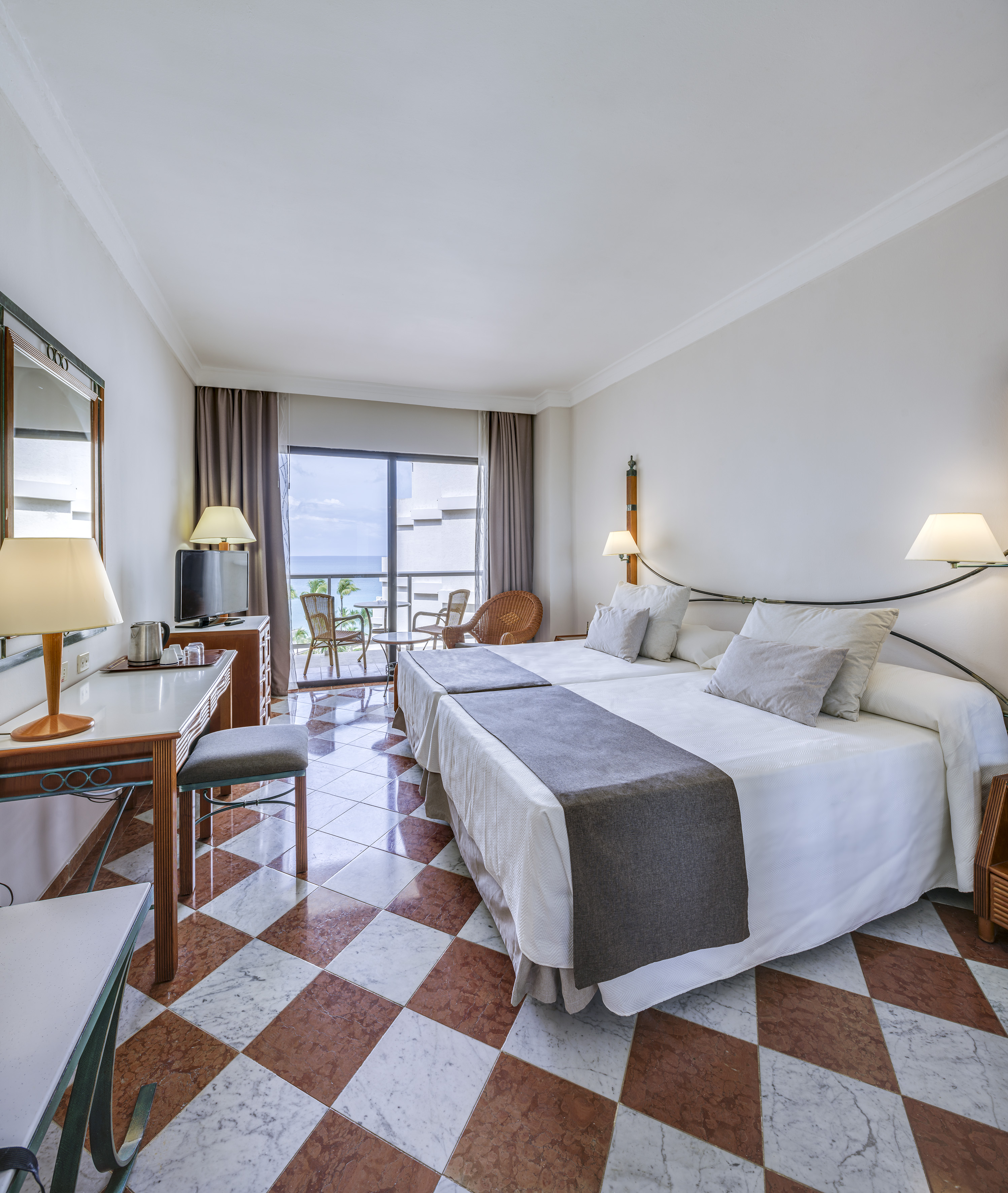 a room with a bed and a table and chairs