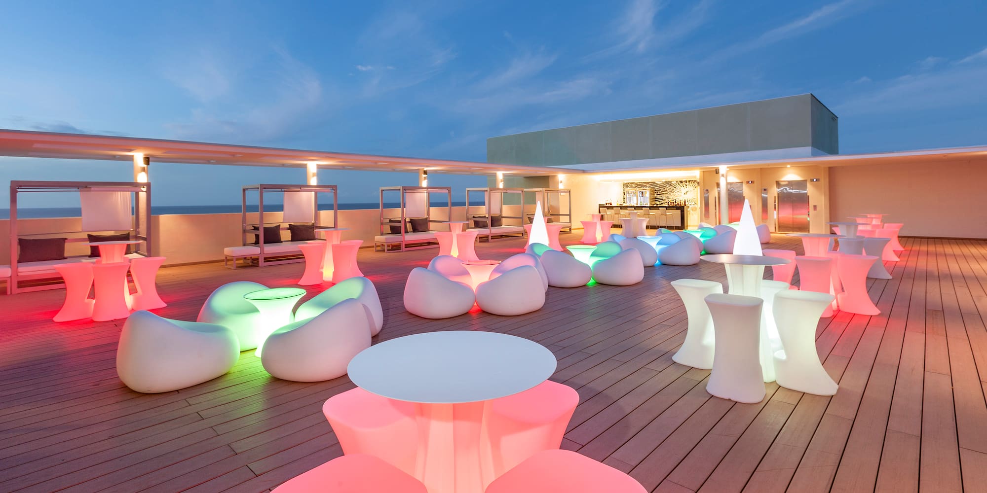 a deck with tables and chairs on it