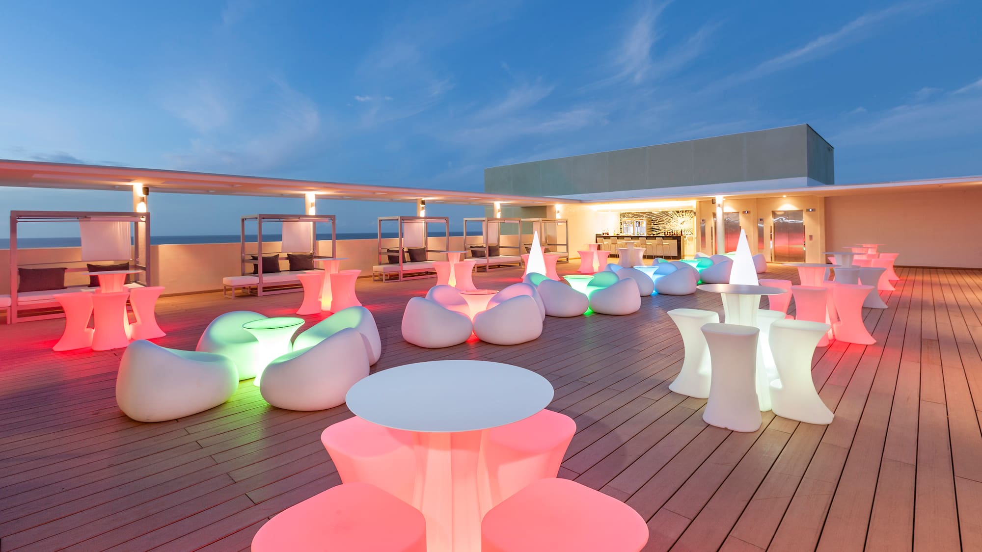 a deck with tables and chairs on it