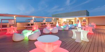 a deck with tables and chairs on it