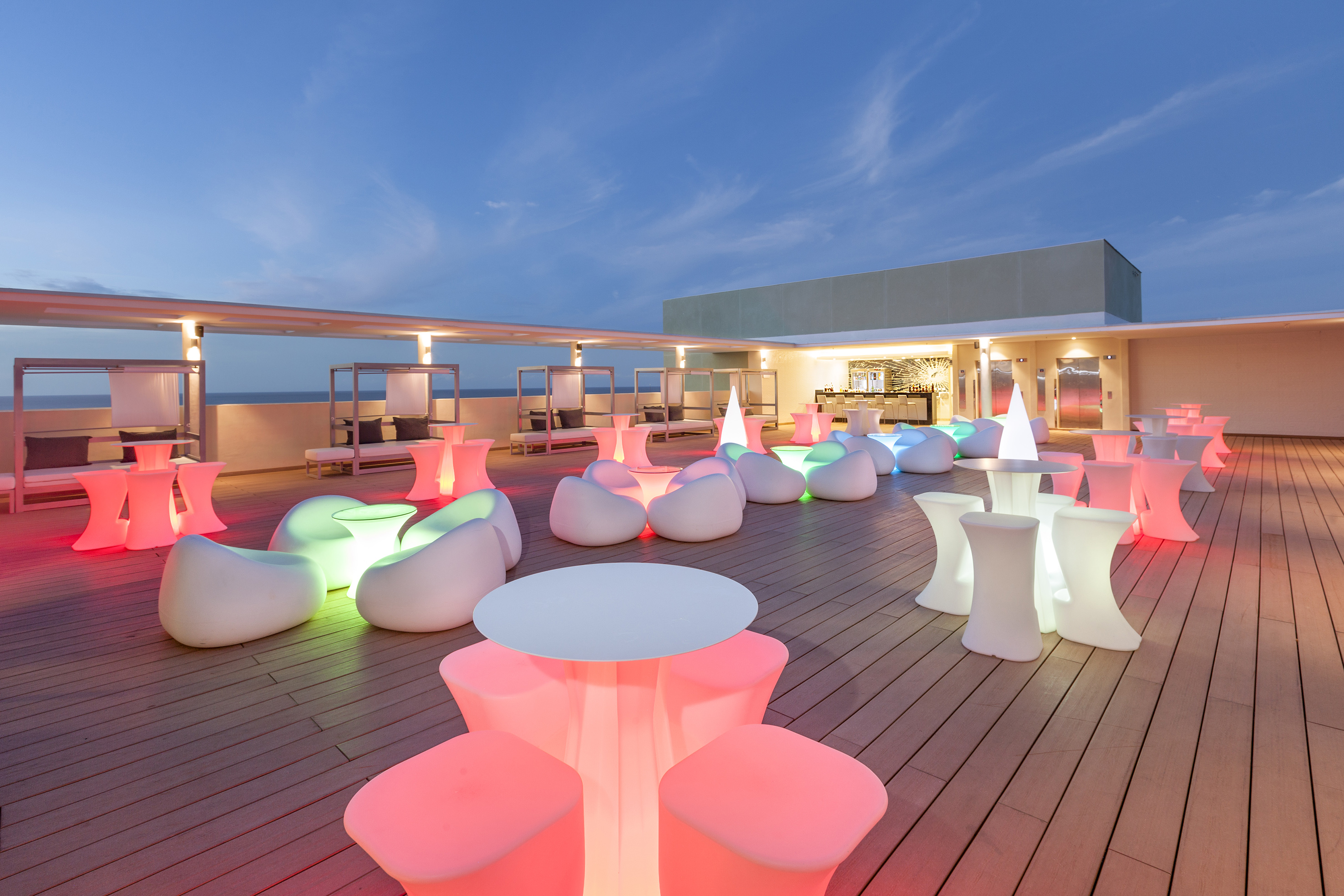 a deck with tables and chairs on it