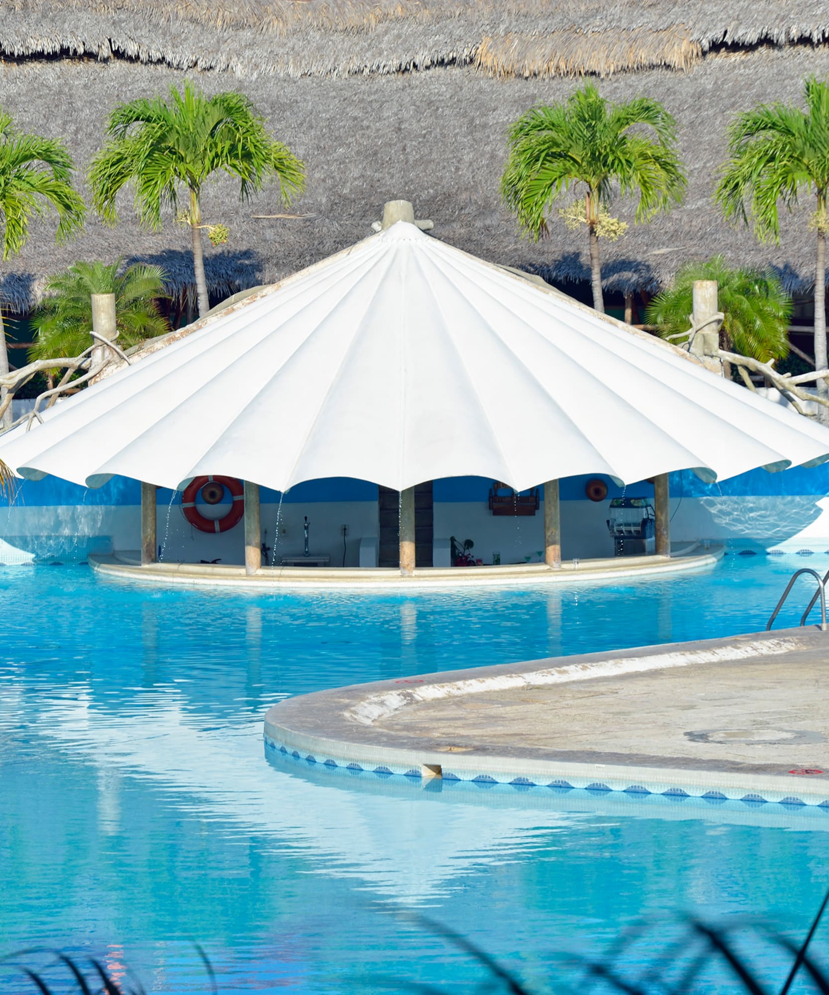 a pool with a white tent