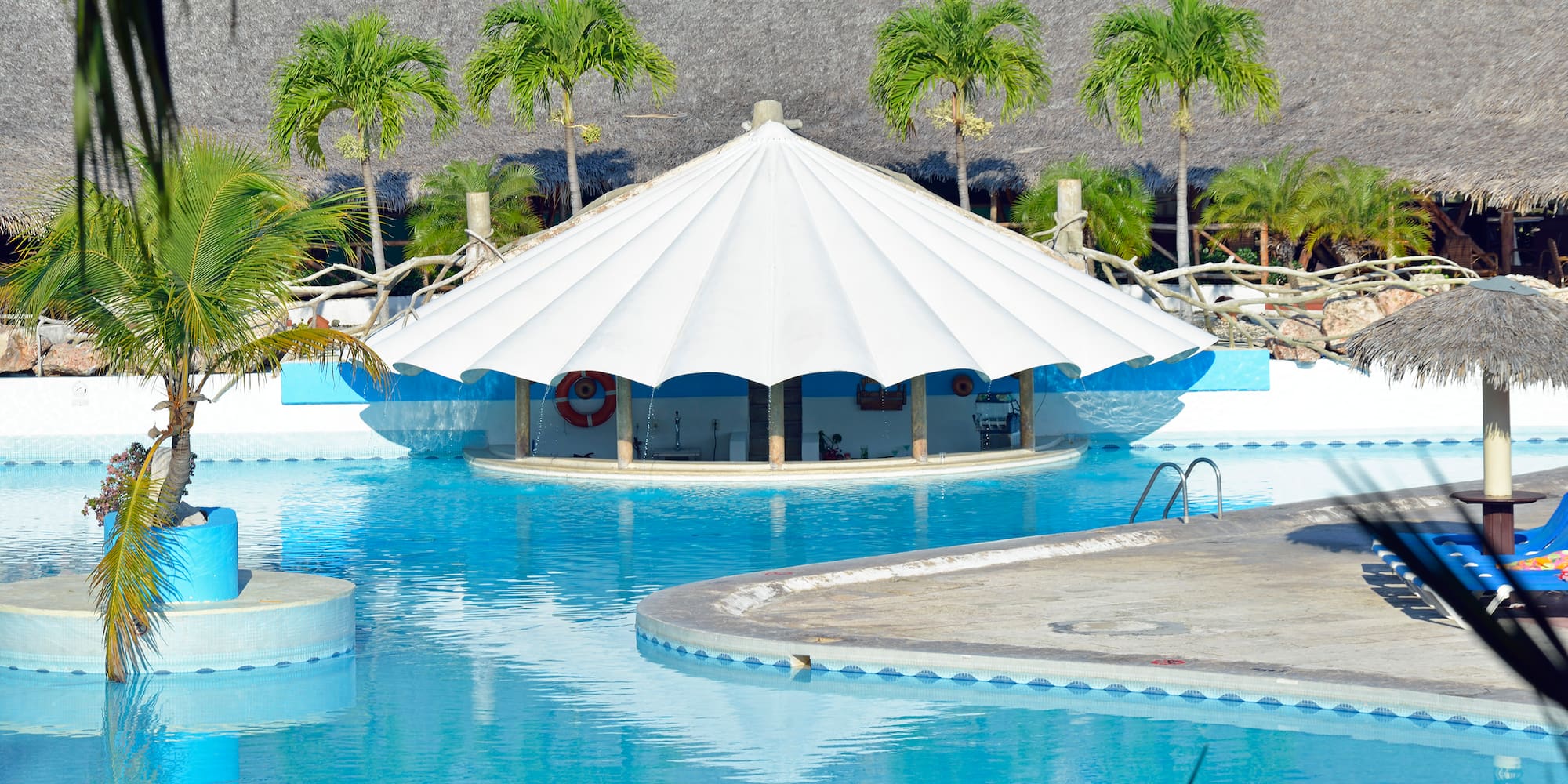 a pool with a white tent
