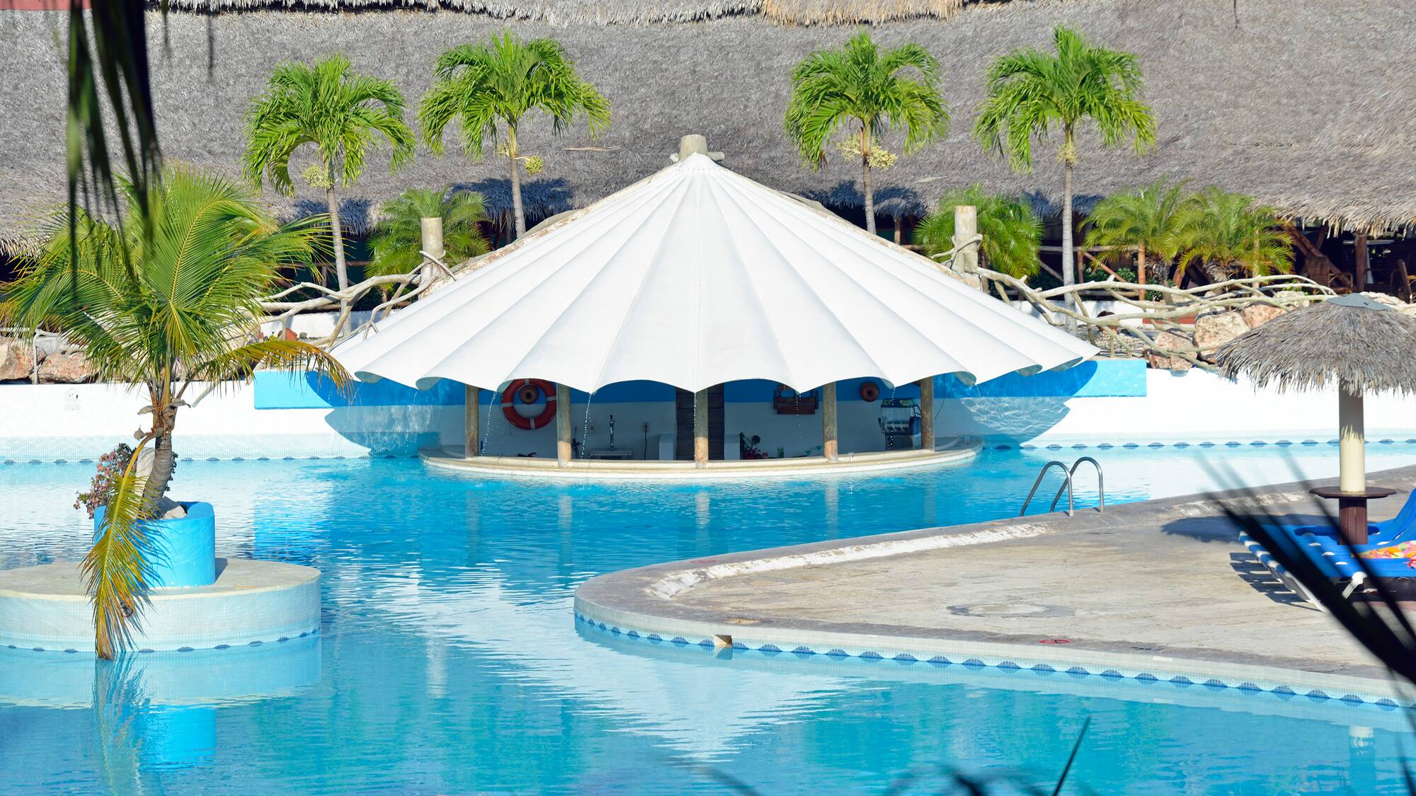 a pool with a white tent