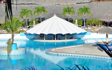 a pool with a white tent
