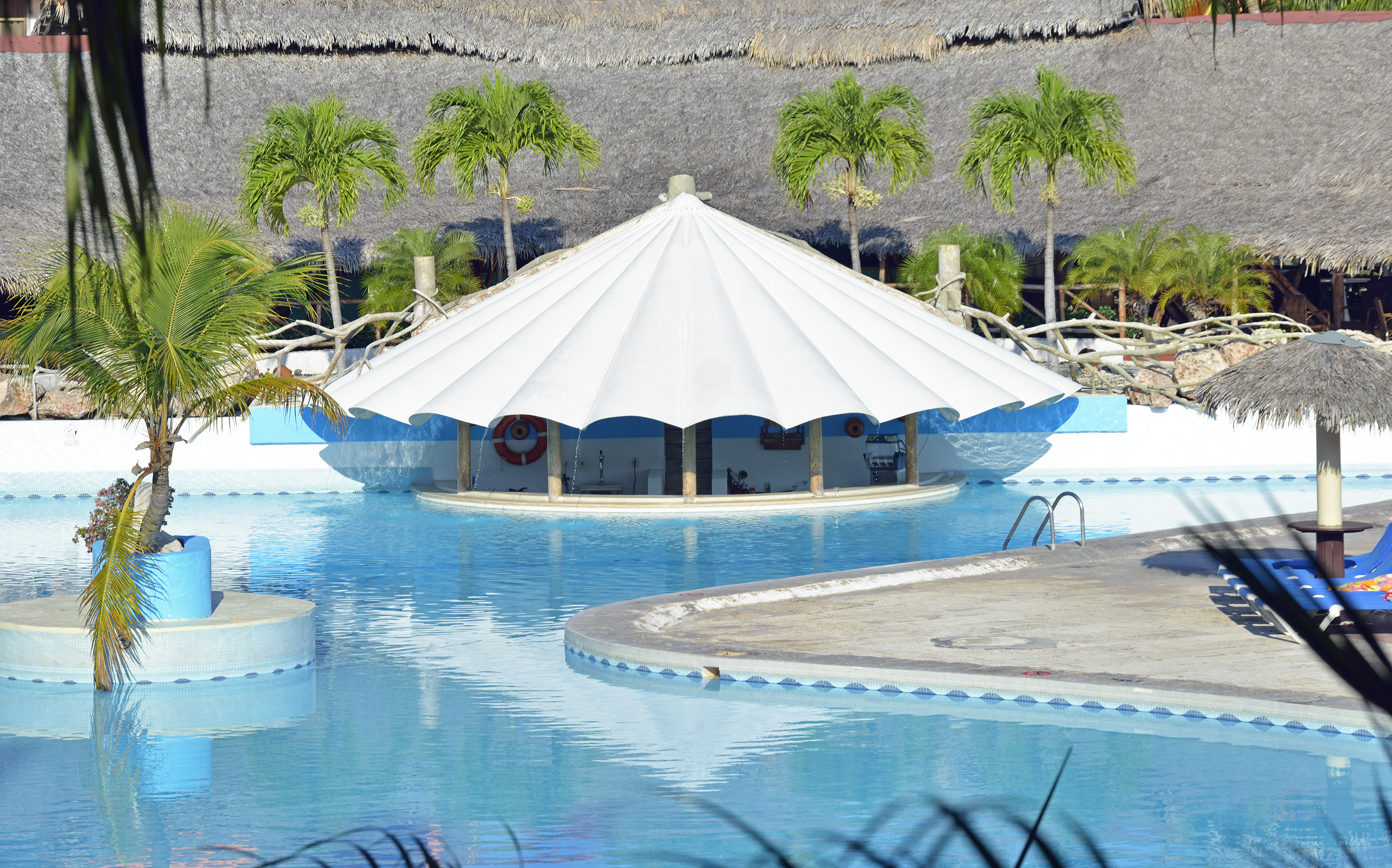 a pool with a white tent