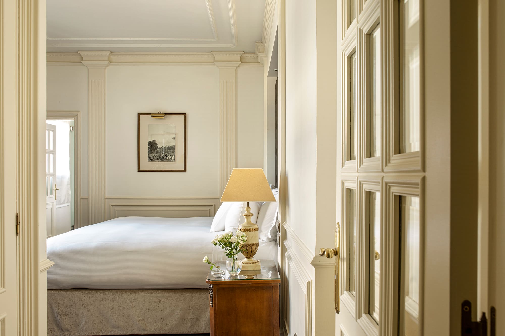 a bedroom with a bed and a lamp