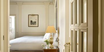 a bedroom with a bed and a lamp
