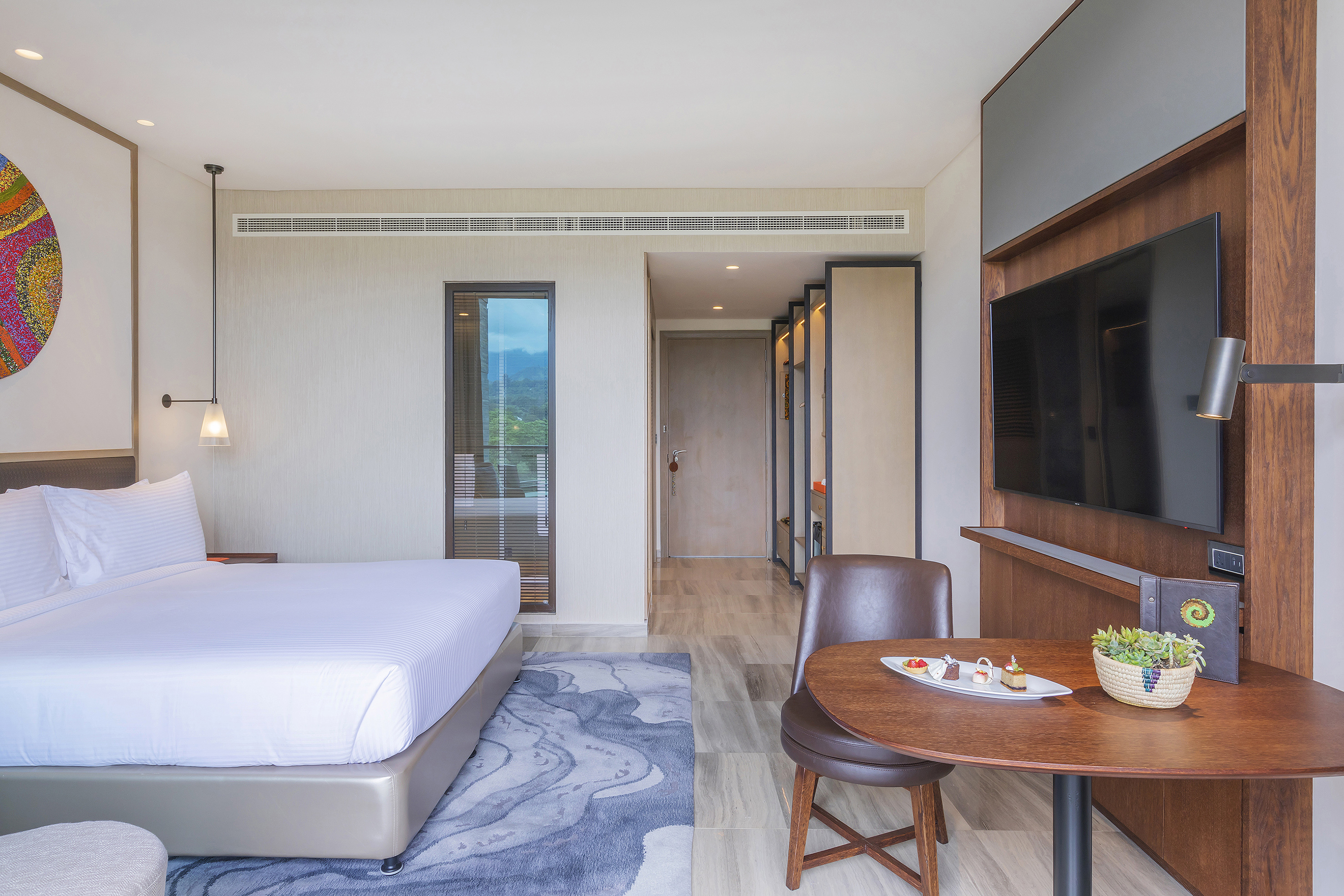 a room with a bed and a tv