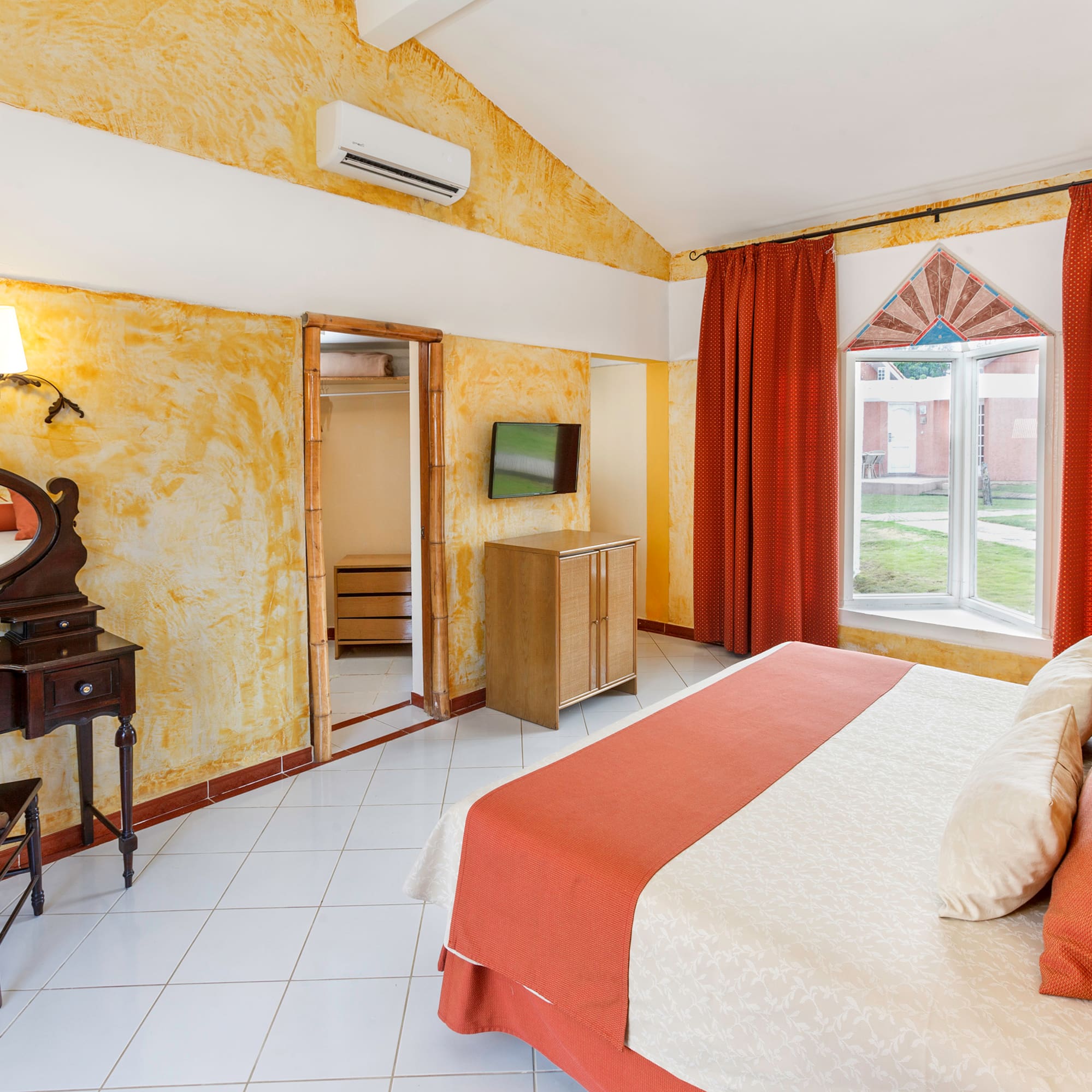 a room with a bed and a mirror