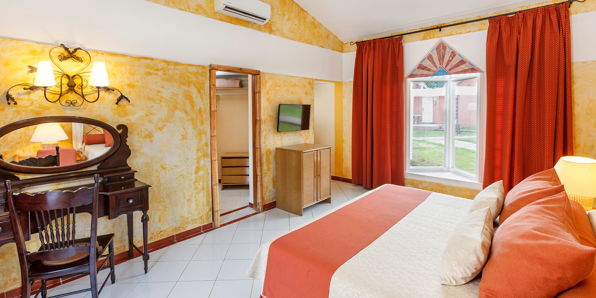 a room with a bed and a mirror