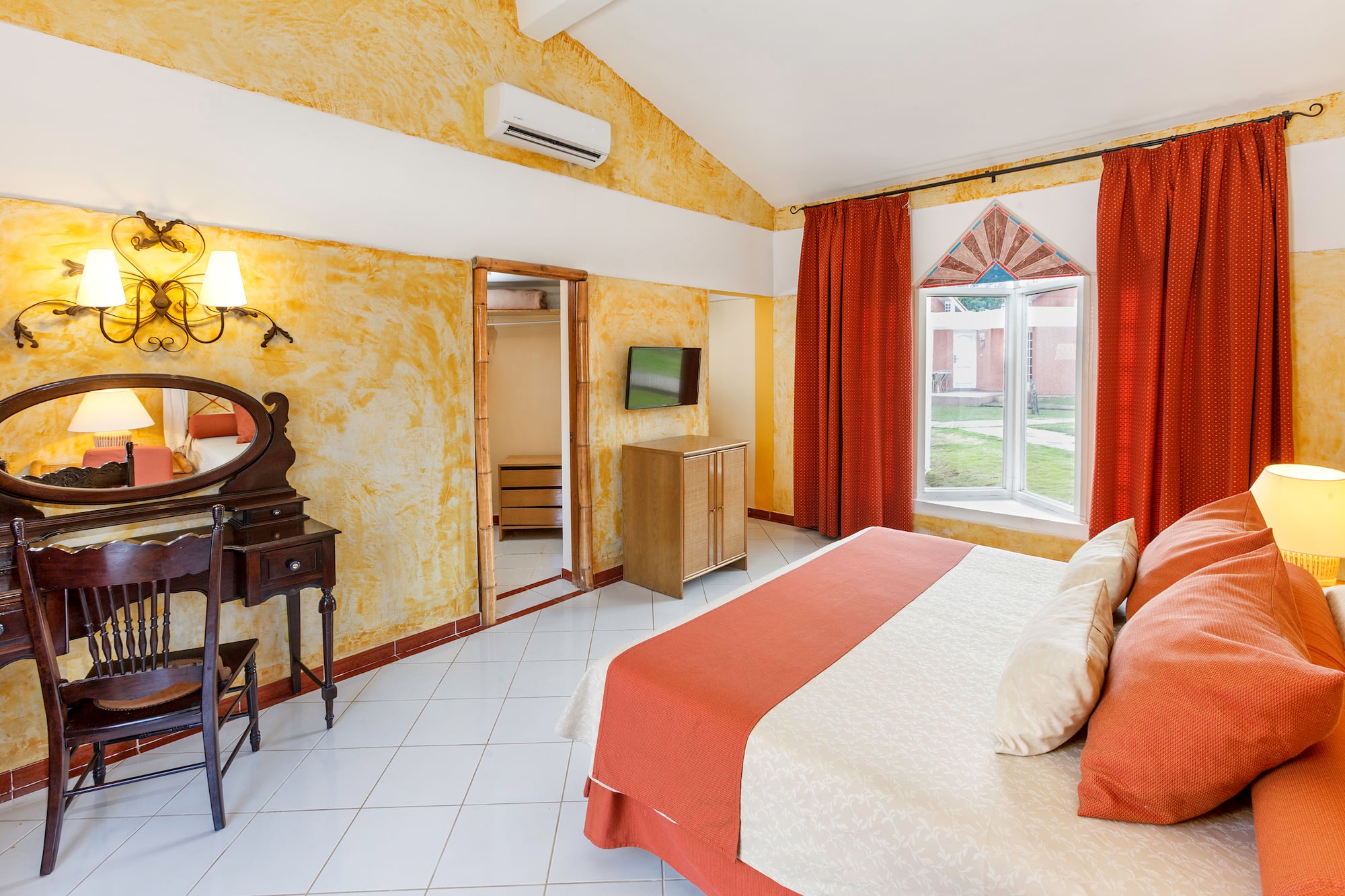 a room with a bed and a mirror